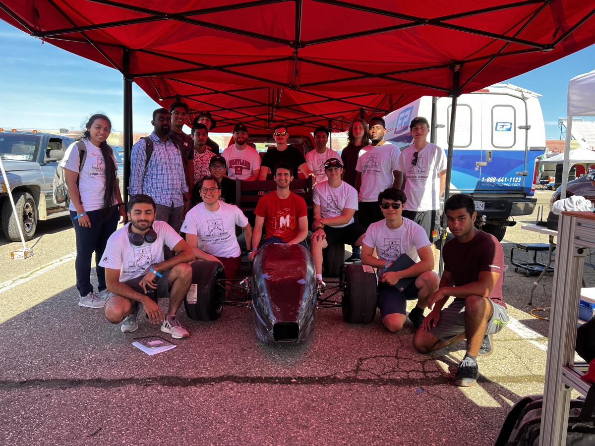 Terps Racing EV group photo under red tent at 2022 FSAE competition
